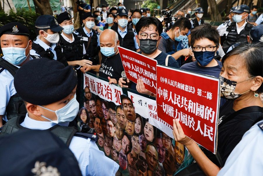 Pro-democracy protesters hold a banner during a protest urging for the release of political prisoners on Chinese National Day, in Hong Kong, China, 1 October 2021. (Tyrone Siu/Reuters)