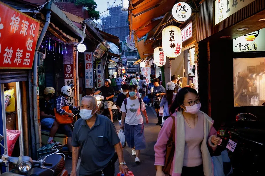 People shop for food at an evening market in Taipei, Taiwan, on 15 June 2023. (Ann Wang/Reuters)