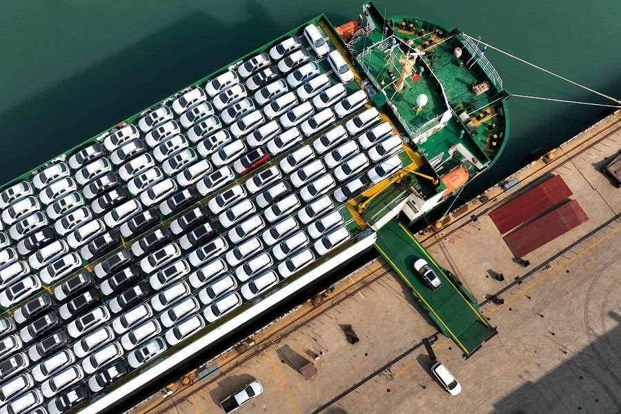 This photo taken on 5 December 2023 shows cars being loaded onto a ship for export at the port in Lianyungang, Jiangsu province, China. (AFP)