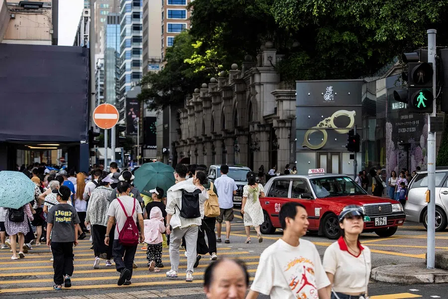 A taxi drives along a road at the Tsim Sha Tui district of Hong Kong, on 11 July 2024. (Isaac Lawrence/AFP)