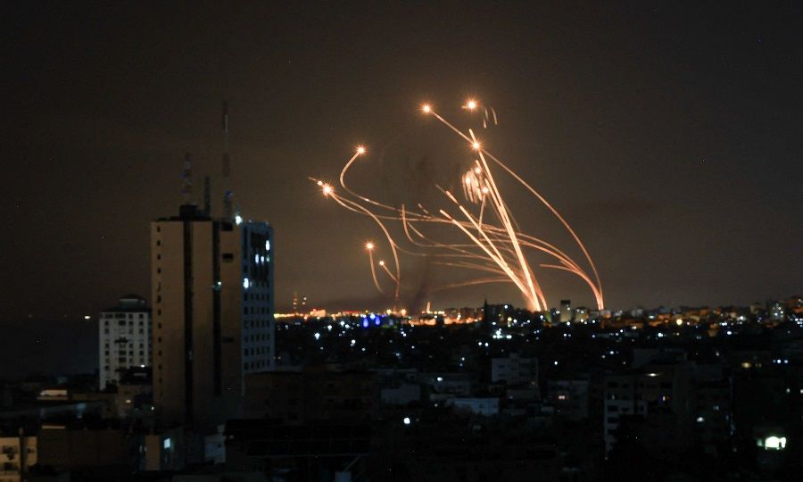 An Israeli missile launched from the Iron Dome defence missile system attempts to intercept a rocket, fired from the Gaza Strip, over the city of Netivot in southern Israel on 8 October 2023. (Mahmud Hams/AFP)