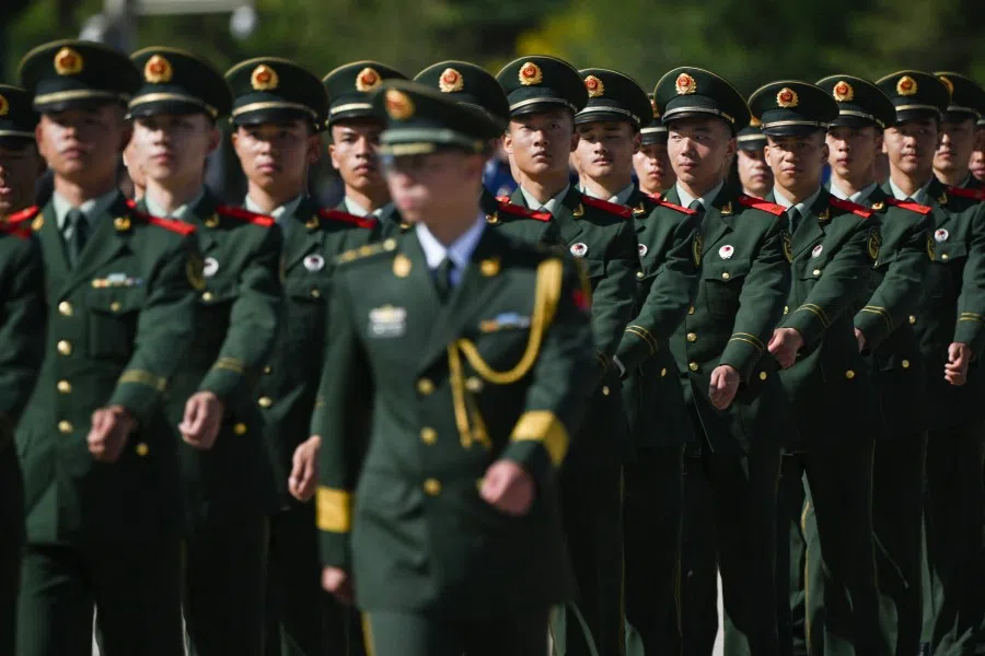 Chinese soldiers march in formation after a wreath laying ceremony at the Monument to the People's Heroes, in honour of fallen national heroes on Martyrs' Day, in Beijing's Tiananmen Square on 30 September 2023. (Photo by Pedro Pardo/AFP)