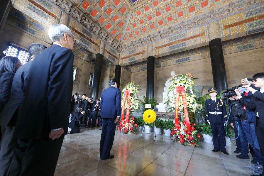 This handout picture taken and released by the office of former Taiwanese President Ma Ying-jeou on 28 March 2023 shows former Taiwanese President Ma Ying-jeou (centre) paying his respects at Dr. Sun Yat-sen's Mausoleum in Nanjing, in China's eastern Jiangsu province. (Handout/Ma Ying-jeou's office/AFP)