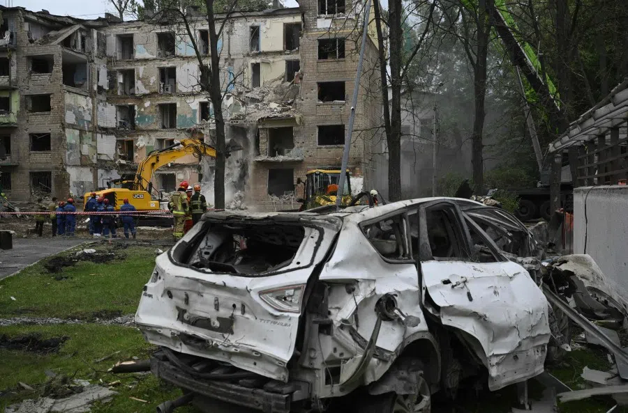 Rescuers clear debris a day after a Russian missile strike left ten people dead and ripped open a residential building, in Kyiv on 24 June 2025, amid the Russian invasion of Ukraine. (Genya Savilov/AFP)