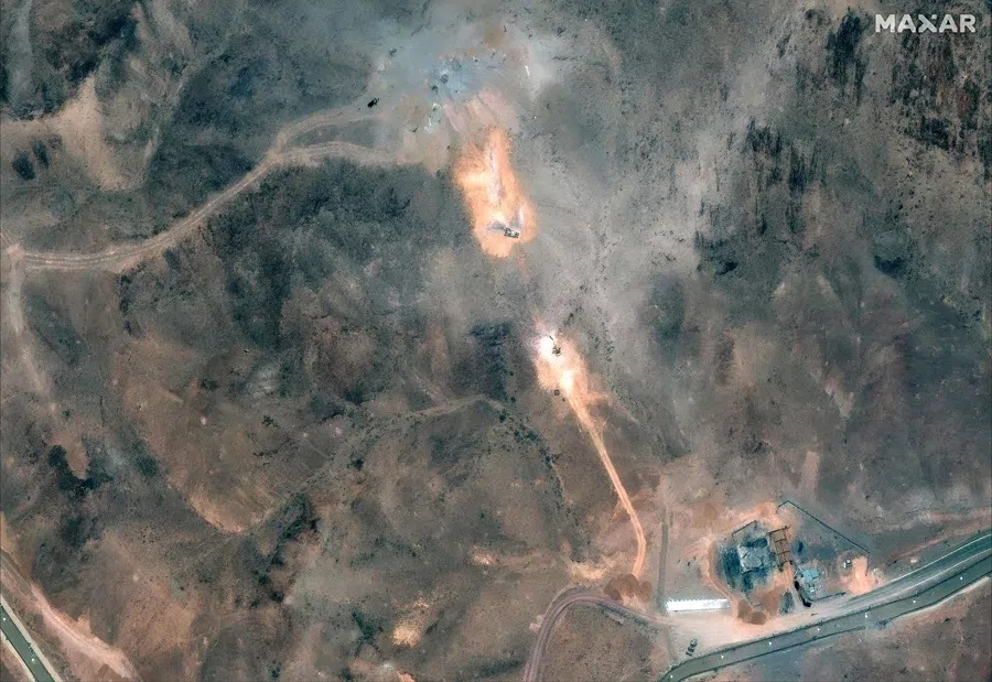 This handout satellite image provided by Maxar Technologies and dated 1 July 2025, shows activity near the perimeter building and southern holes caused by the 22 June US airstrike on the Fordo (Fordow) Fuel Enrichment Plant complex, about 30 kilometres north of Qom in central Iran. (Satellite image ©2025 Maxar Technologies/AFP)