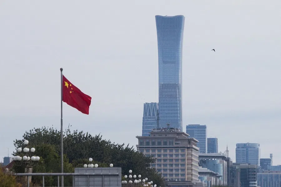 Chinese national flag flies in front of skyscrapers of the central business district as China’s Communist Party leaders open the fifth plenary session of the 20th Central Committee in Beijing, China, 26 October 2026.