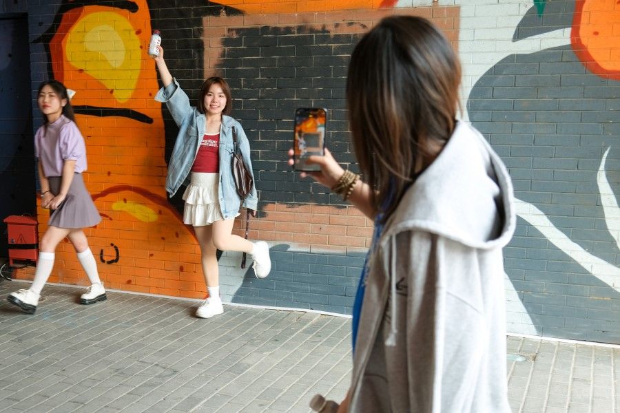Young people in Beijing snapping photos of one another, 25 May 2023.