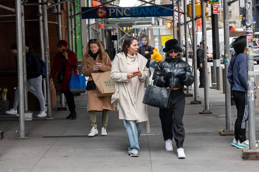 People walk through Lower Manhattan on 5 April 2024 in New York City, US. (Spencer Platt/Getty Images/AFP)