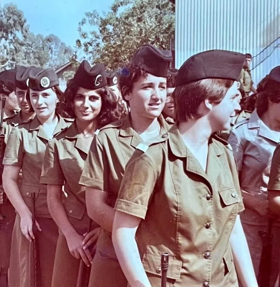 A newly enlisted Israeli female soldier posing for the camera.