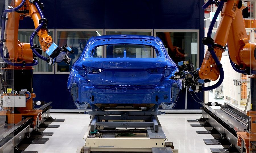 Robots measure the thickness of paint on a car body at Germany's carmaker BMW plant in Leipzig, Germany, on 20 October 2022. (Ronny Hartmann/AFP)