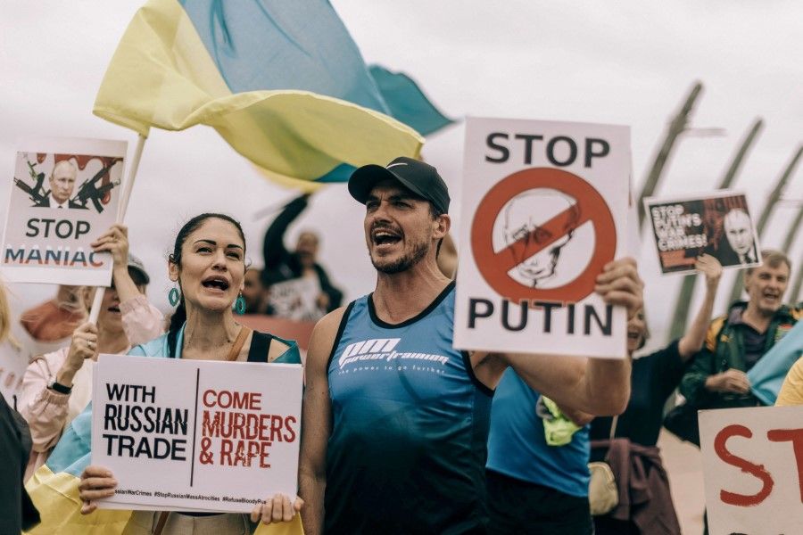 Protesters from Ukrainian Association of South Africa and civil society activists take part in a demonstration at the Umhlanga beach in Durban on 18 February 2023, against South Africa's joint military exercise with Russia and China along its eastern coast city of Richards Bay. (Rajesh Jantilal/AFP)