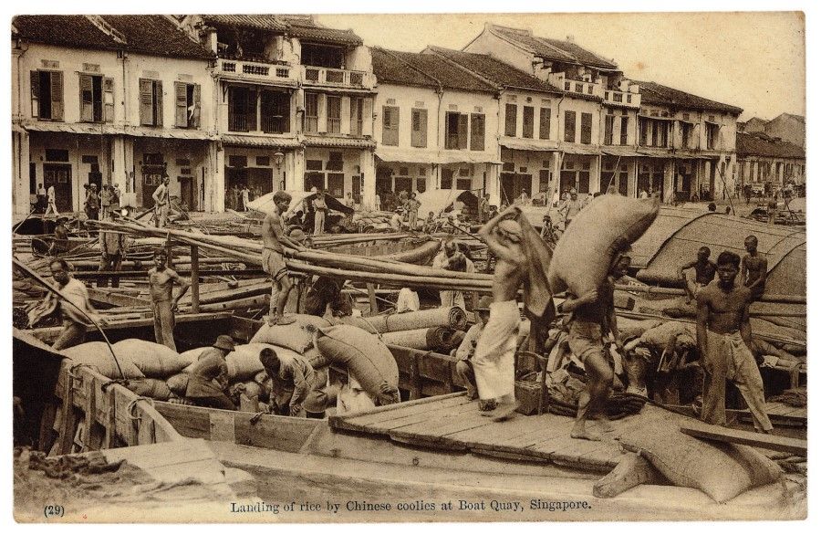 Coolies unloading rice from a boat at Boat Quay, Singapore, 1916. (Singapore Philatelic Museum)