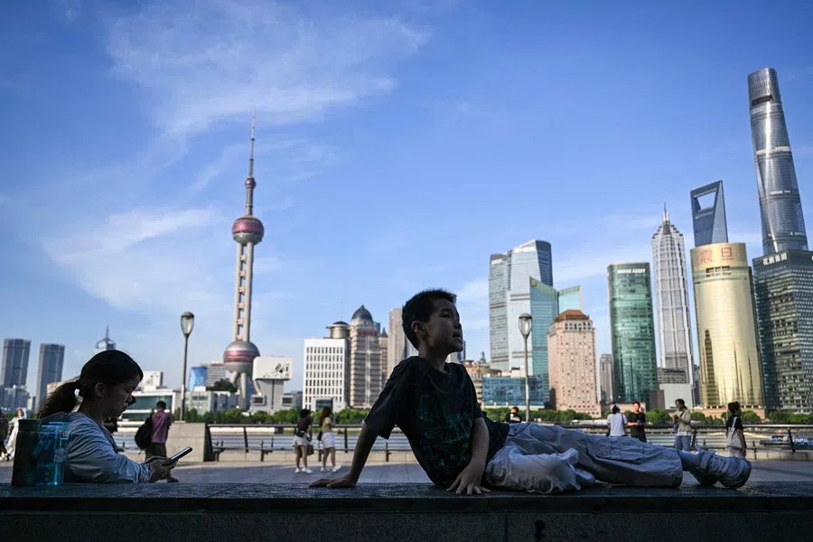 People visit The Bund promenade along the Huangpu River in Shanghai on 4 July 2025. (Hector Retamal/AFP)