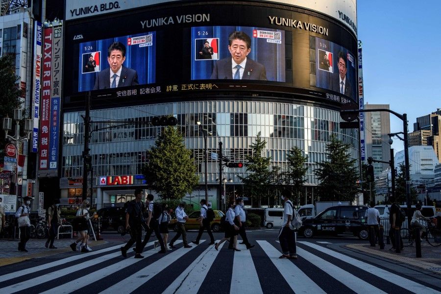 Japanese Prime Minister Shinzō Abe is seen on a large screen during a live press conference in Tokyo on 28 August 2020, as he announced that he will resign over health problems.