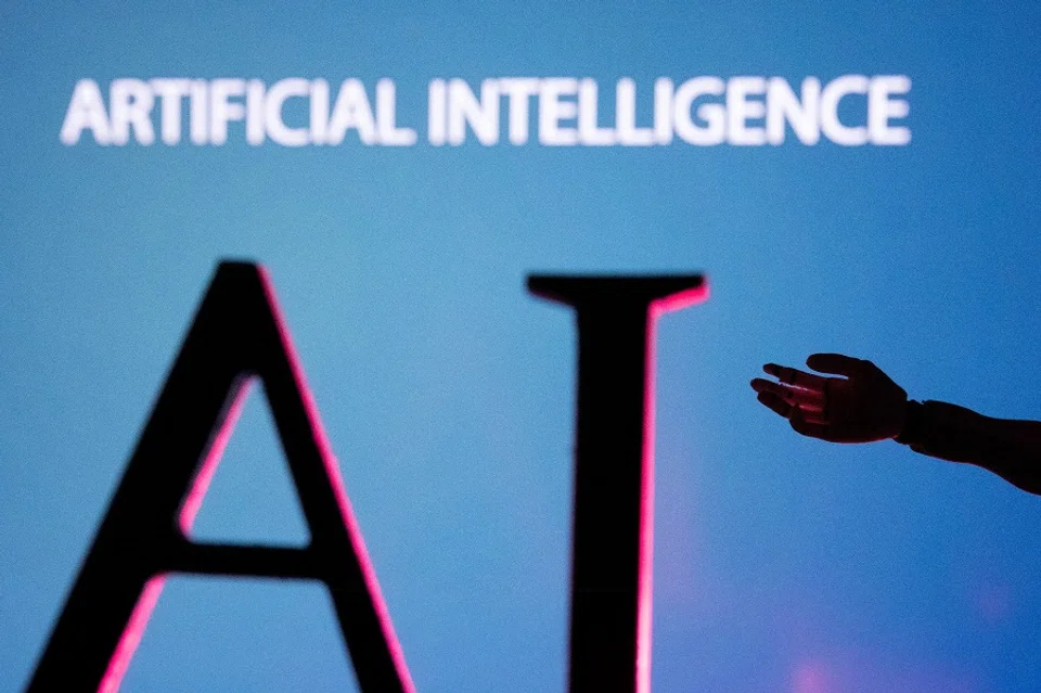 AI (Artificial Intelligence) letters and a robot hand miniature are shown in this illustration taken on 23 June 2023. (Dado Ruvic/Illustration/Reuters)