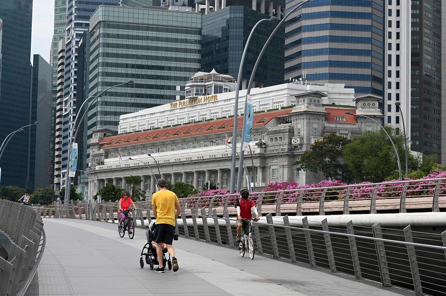 People stroll along Marina Bay in Singapore on 14 October 2020. (Roslan Rahman/AFP)