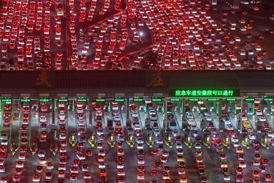 Drivers merge onto expressway lanes after passing through the Wuzhuang toll station in Chuzhou, eastern China's Anhui province on 22 February 2026. (CN-STR/AFP)