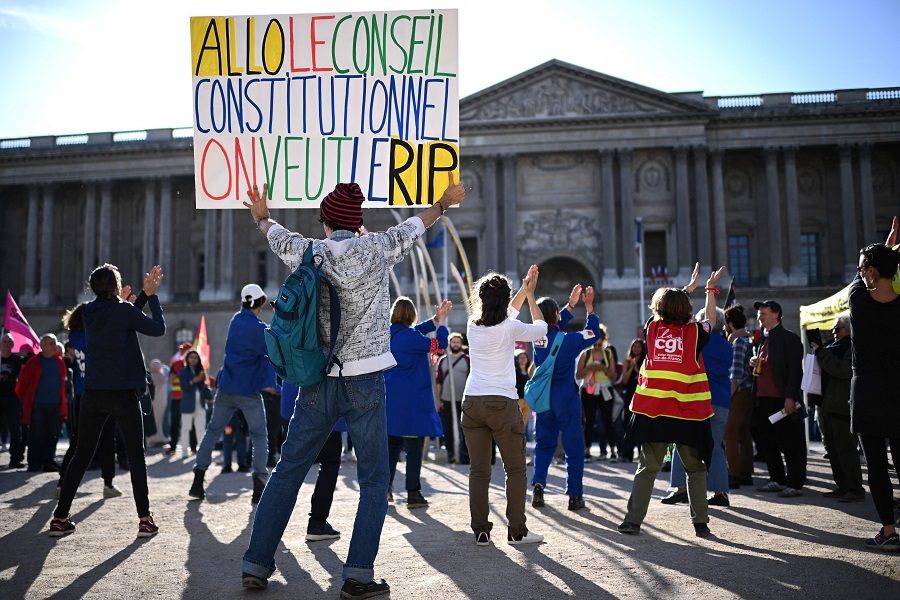 A protester holds a placard reading "Allo Conseil Constitutionnel, we want the RIP (Referendum d'Initiative Partagee)" during a demonstration at Place du Louvre following a decision by France's Conseil Constitutionnel (constitutional council) rejected a second "Referendum d'Initiative Partagee", a citizen initiative to initiate a referendum on the government's pension reform, in Paris, France, on 3 May 2023. (Christophe Archambault/AFP)