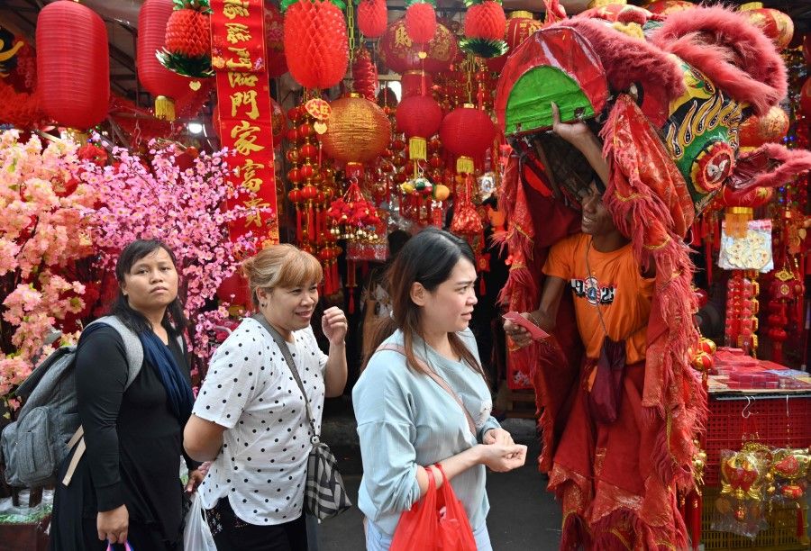 Chinese Indonesians at a market in Jakarta ahead of Chinese New Year. Chinese Indonesians were not allowed to speak Chinese for a long time, until 1999. (Adek Berry/AFP)