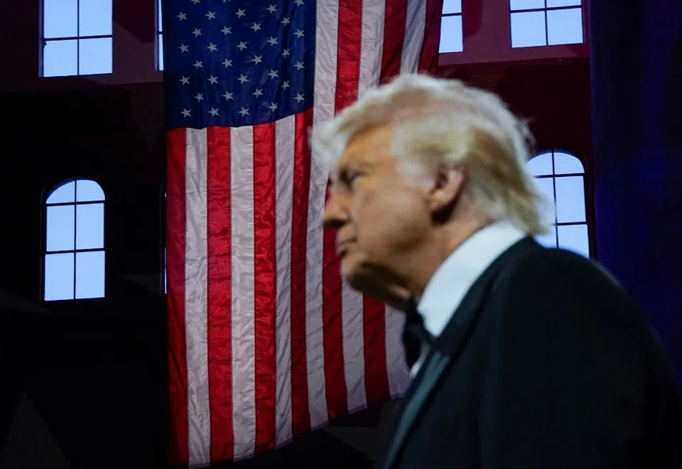 A US flag is pictured in the background as US President Donald Trump attends the National Republican Congressional Committee (NRCC) dinner at the National Building Museum in Washington, DC, US, on 8 April 2025. (Nathan Howard/Reuters)