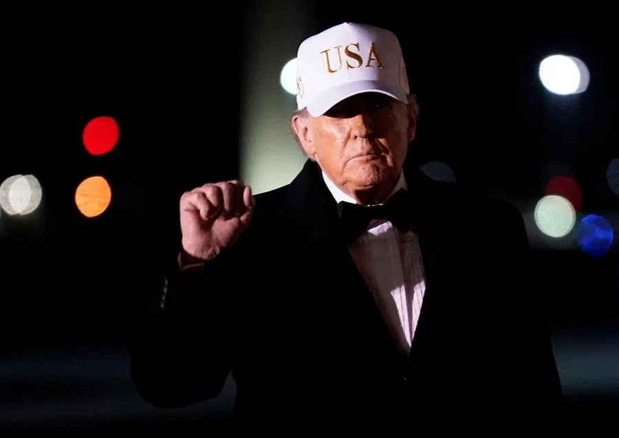 US President Donald Trump gestures after disembarking from Air Force One on his arrival at Palm Beach International Airport in West Palm Beach, Florida, US, on 31 January 2026.