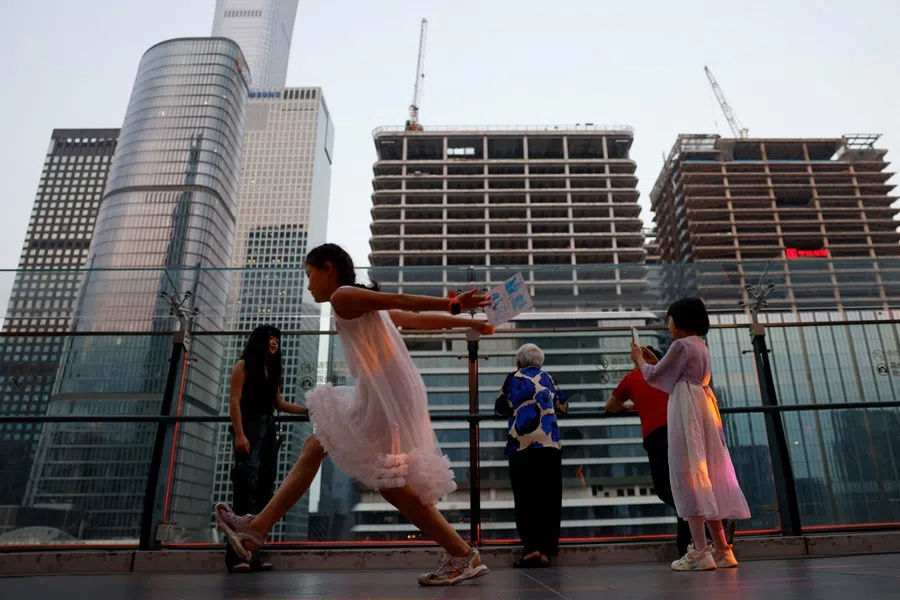 People visit a terrace of a shopping mall overlooking the central business district, in Beijing, China, on 11 August 2025.