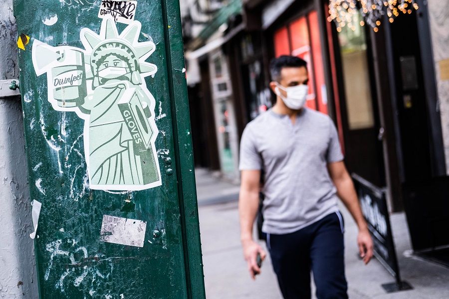 A sticker of the Statue of Liberty wearing a mask is seen on 10 May 2020 in the Manhattan borough of New York City. (Jeenah Moon/Getty Images/AFP)