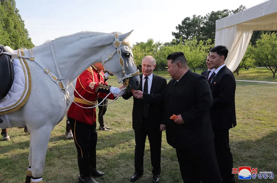This picture taken on 19 June 2024 and released on 20 June 2024 from North Korea’s official Korean Central News Agency (KCNA) via KNS shows North Korea’s leader Kim Jong Un and Russia’s President Vladimir Putin in the garden of the Kumsusan State Guesthouse in Pyongyang.  (KCNA via KNS/AFP)