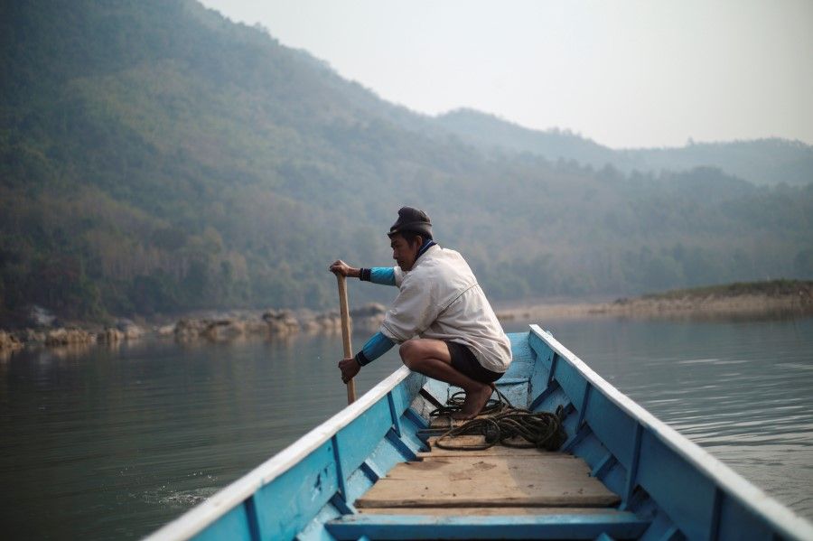 A local villager drive a boat where the future site of the Luang Prabang Dam will be on the Mekong River, outskirt of Luang Prabang province, Laos, February 5, 2020. (Panu Wongcha-um/REUTERS)