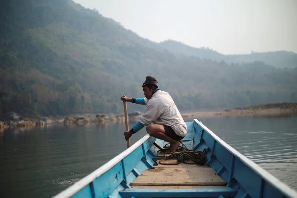 A local villager drive a boat where the future site of the Luang Prabang Dam will be on the Mekong River, outskirt of Luang Prabang province, Laos, February 5, 2020. (Panu Wongcha-um/REUTERS)