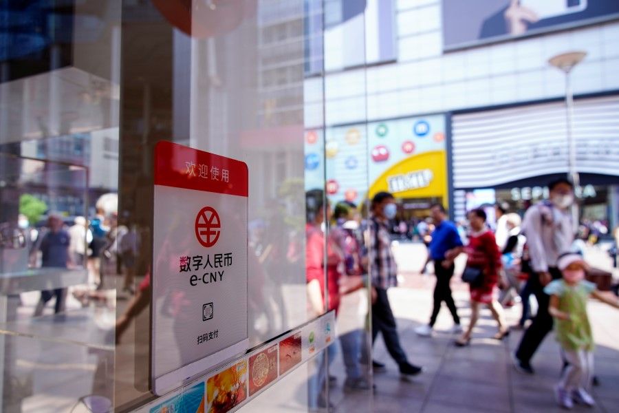 A sign indicating digital yuan, also referred to as e-CNY, is pictured at a shopping mall in Shanghai, China, 5 May 2021. (Aly Song/Reuters)