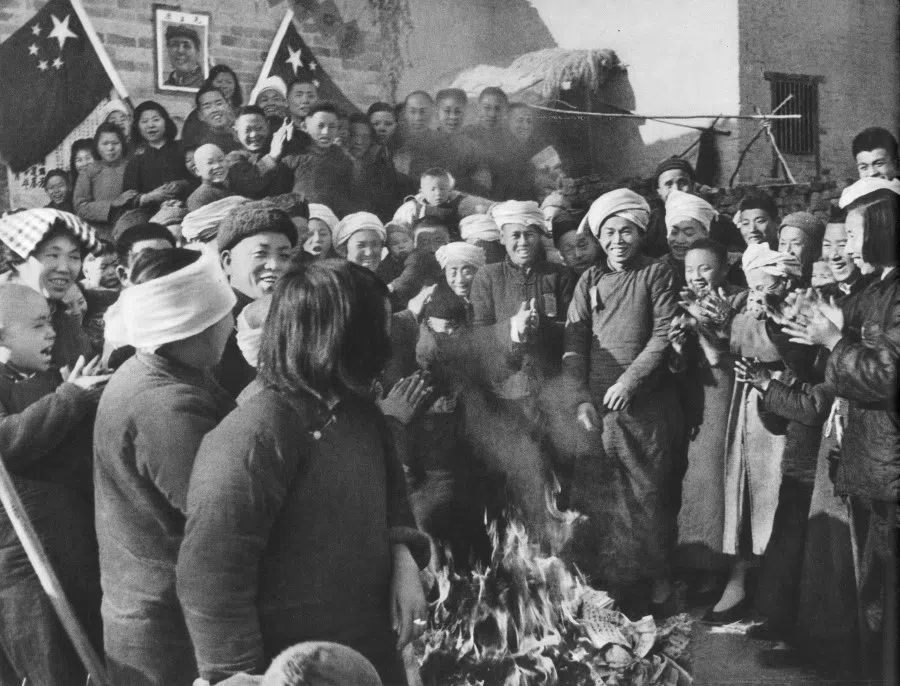 In 1950, after the establishment of the new China, the nationwide land reform was implemented, confiscating land and property from landlords and distributing them to poor peasants. The photo shows poor peasants burning rent receipts.