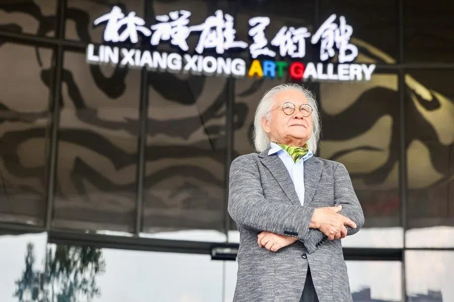 Artist and gold miner Lin Xiang Xiong standing in front of the Lin Xiang Xiong Art Gallery, Penang, Malaysia, April 2026.