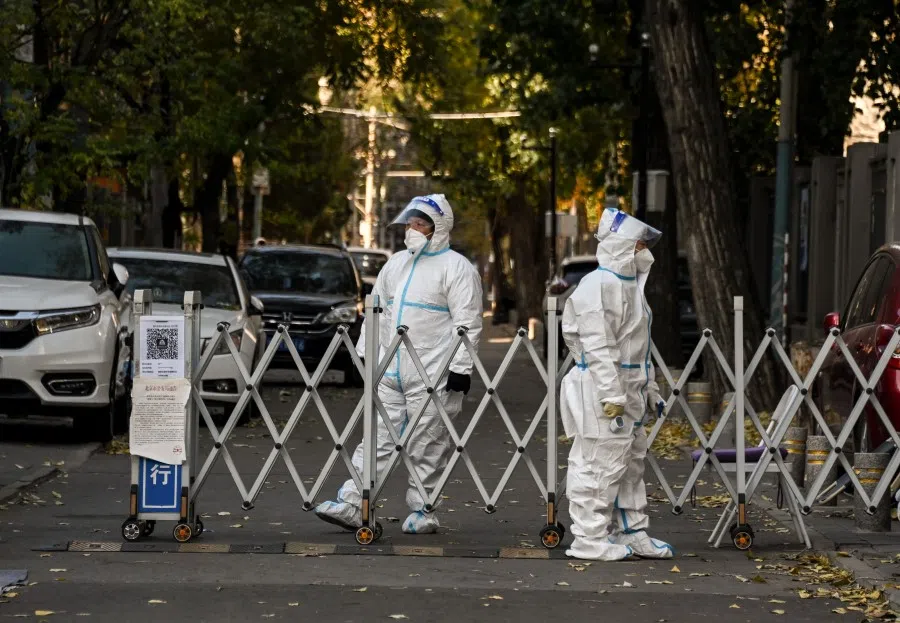 Security personnel guard an entrance to a residential area under lockdown due to Covid-19 coronavirus restrictions in Beijing on 26 November 2022. (Noel Celis/AFP)