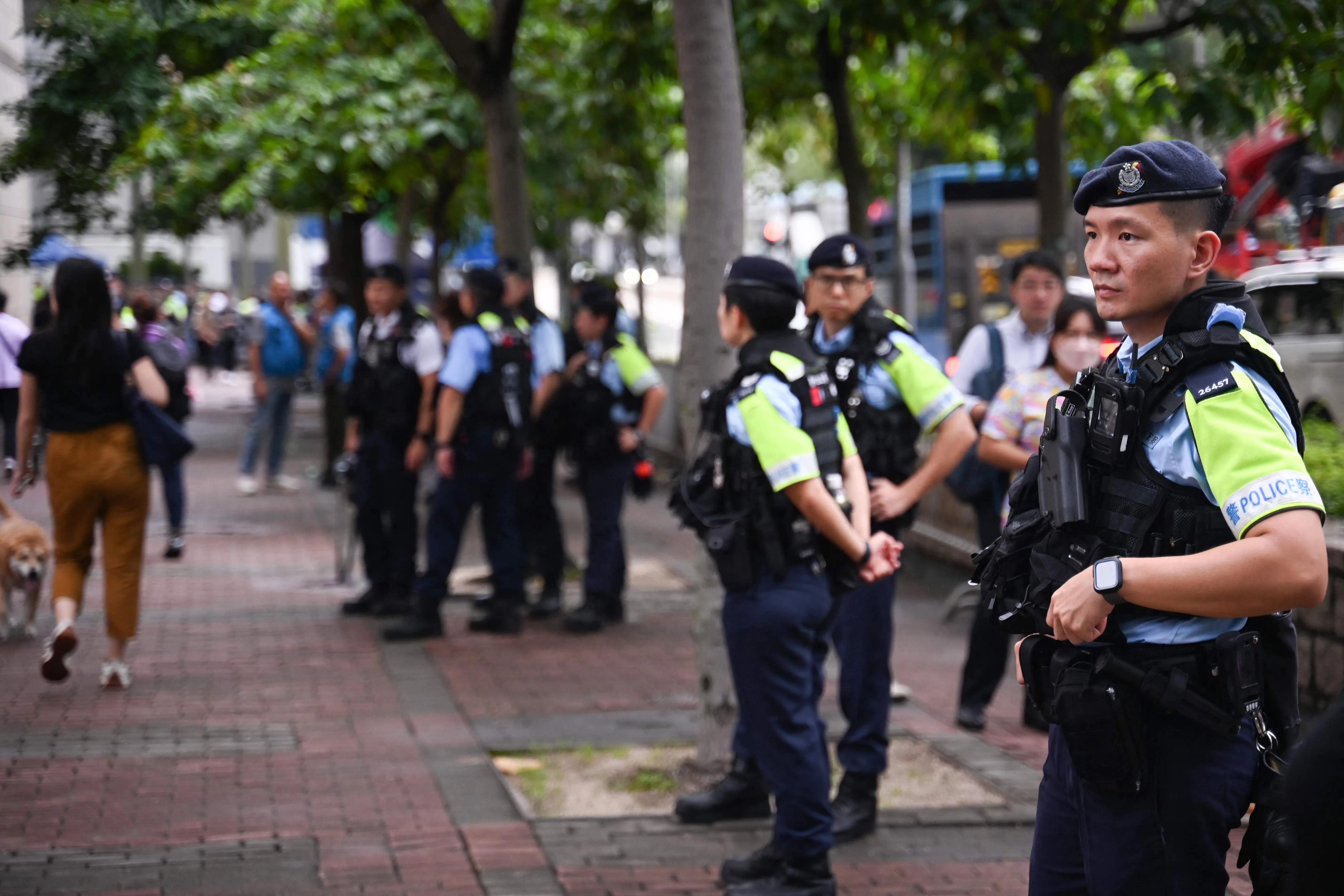 Policemen keep watch outside the West Kowloon Magistrates’ Court in Hong Kong on 25 June 2024, where pro-democracy activists are attending their mitigation session as part of the biggest trial for pro-democracy campaigners under the Beijing-imposed national security law. (Peter Parks/AFP)