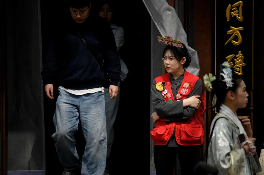 A worker waits for customers at the entrance of a restaurant in Beijing, China, on 11 April 2025. (Wang Zhao/AFP)