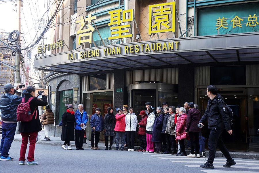 People pose for photographs in front of Tai Sheng Yuan restaurant, on which the show's Zhi Zhen Yuan restaurant is based, in Shanghai, China, on 5 January 2024. (CNS)