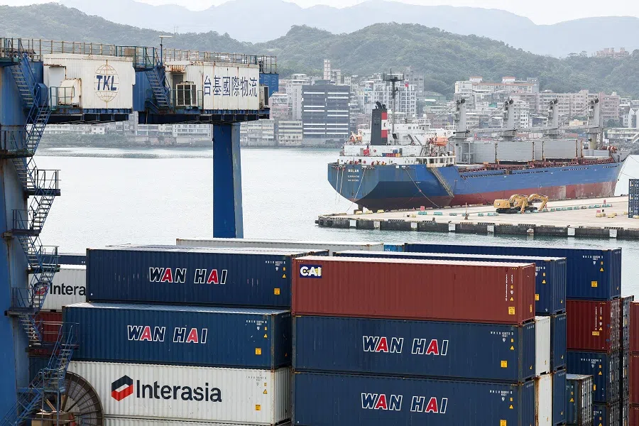 A cargo ship and containers are seen at the Port of Keelung on 3 April 2025. (I-Hwa Cheng/AFP)
