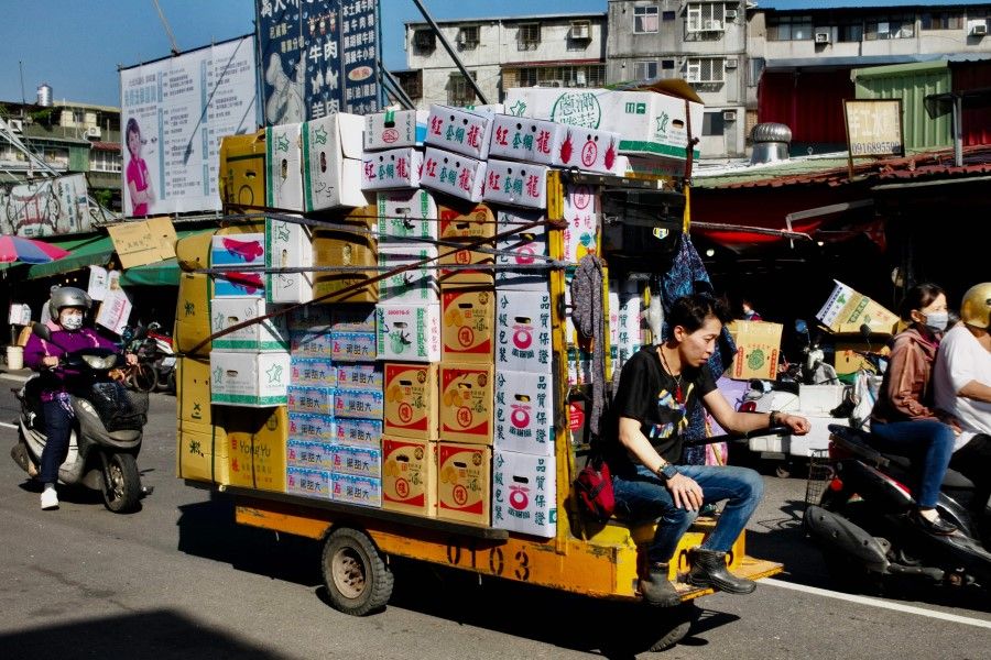 A worker drives a motor trolley past the First Fruit and Vegetable Wholesale Market in Taipei on 14 January 2023. (Sam Yeh/AFP)