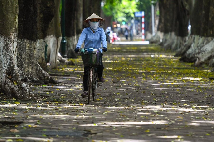 A woman cycles in Hanoi on 21 September 2020. (Nhac Nguyen/AFP)