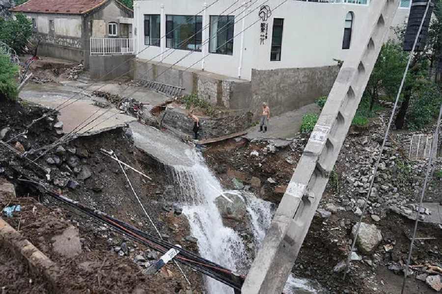 A road was damaged by a flood in Shuiyuzui village in Mentougou district, Beijing, on 1 August 2023.