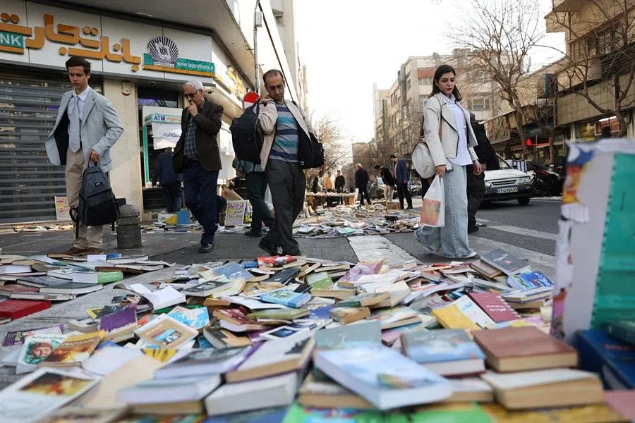 People look at books on a street in Tehran, Iran, on 19 February 2026. (Majid Asgaripour/West Asia News Agency via Reuters)