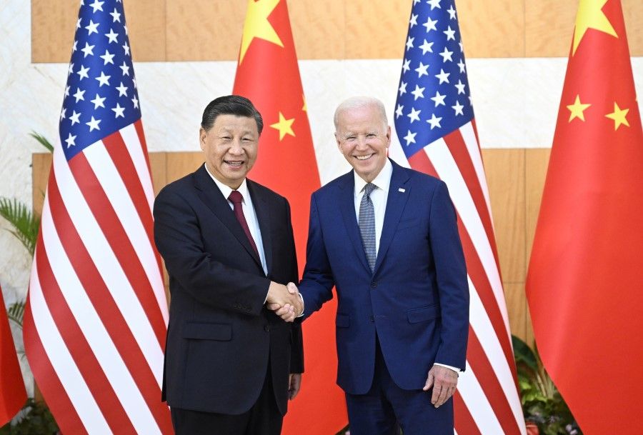 US President Joe Biden shakes hands with Chinese President Xi Jinping as they meet on the sidelines of the G20 Leaders' Summit in Bali, Indonesia, 14 November 2022. (Kevin Lamarque/Reuters)