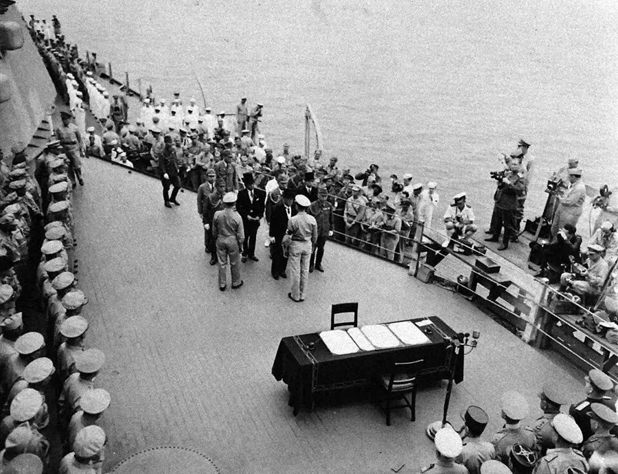 Surrender of Japan, Tokyo Bay, on 2 September 1945. Arrival of Japanese emissaries onboard USS Missouri. Foreign Minister Mamoru Shigemitsu (wearing top hat) and General Yoshijiro Umezu, chief of the army general staff can be seen in the centre. (Wikimedia)
