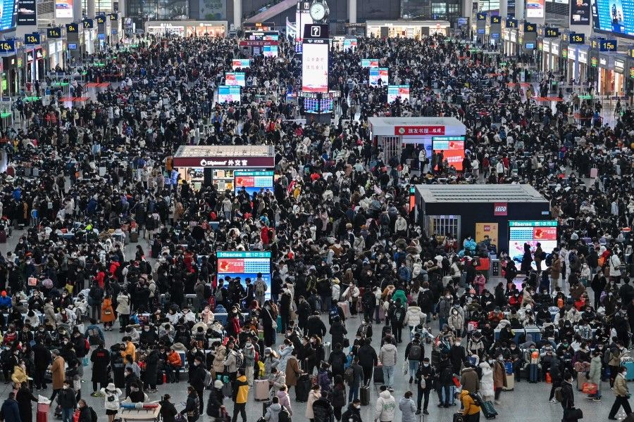 Passengers wait for their train at Hongqiao railway station in Shanghai on 20 January 2023, as annual migration begins with people heading back to their hometowns for Lunar New Year celebrations. (Hector Retamal/AFP)