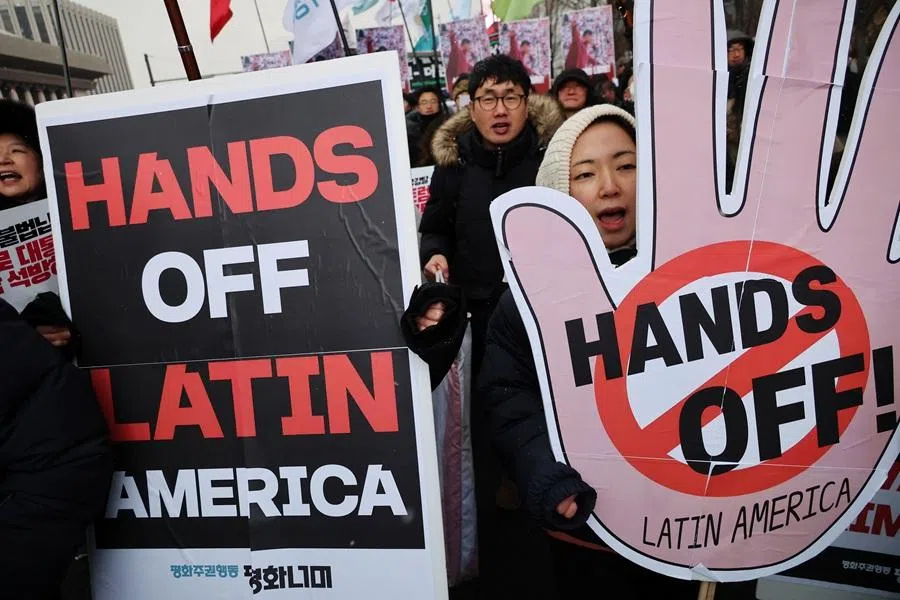 Activists march on a street during an anti-Trump rally to condemn the US conducting a military operation on Venezuela to capture its President Nicolás Maduro and his wife Cilia Flores, in central Seoul, South Korea, on 10 January 2026.