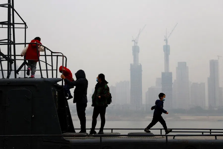 Children play on a boat by the Yangtze River, amid the Covid-19 outbreak, in Wuhan, Hubei province, China, 31 December 2022. (Tingshu Wang/Reuters)