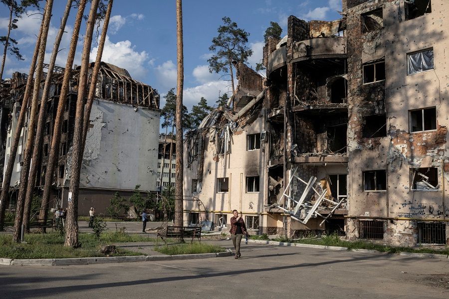 People look at destroyed buildings in Irpin, outside Kyiv, as Russia's attacks on Ukraine continue, 9 June 2022. (Marko Djurica/File Photo/Reuters)