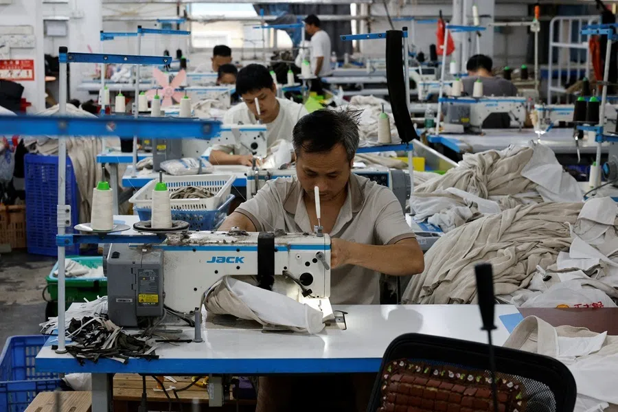 Employees work on a production line at a garment factory in Panyu District, Guangzhou, Guangdong province, China, on 27 July 2026.
