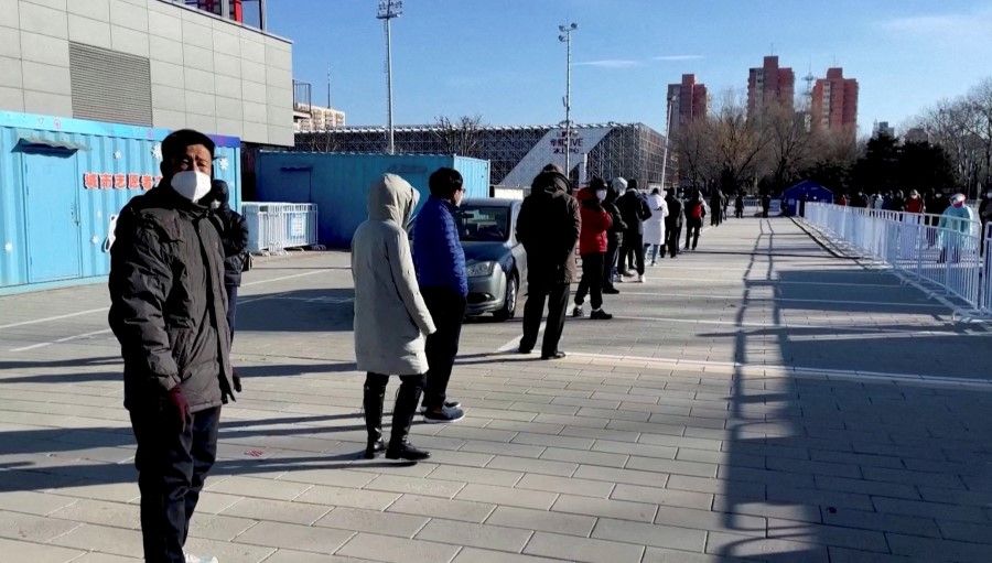 Residents queue to receive a nasal spray Covid-19 booster vaccine in Beijing, China, 17 December 2022 in this still image obtained from a video. (Reuters TV/via Reuters)